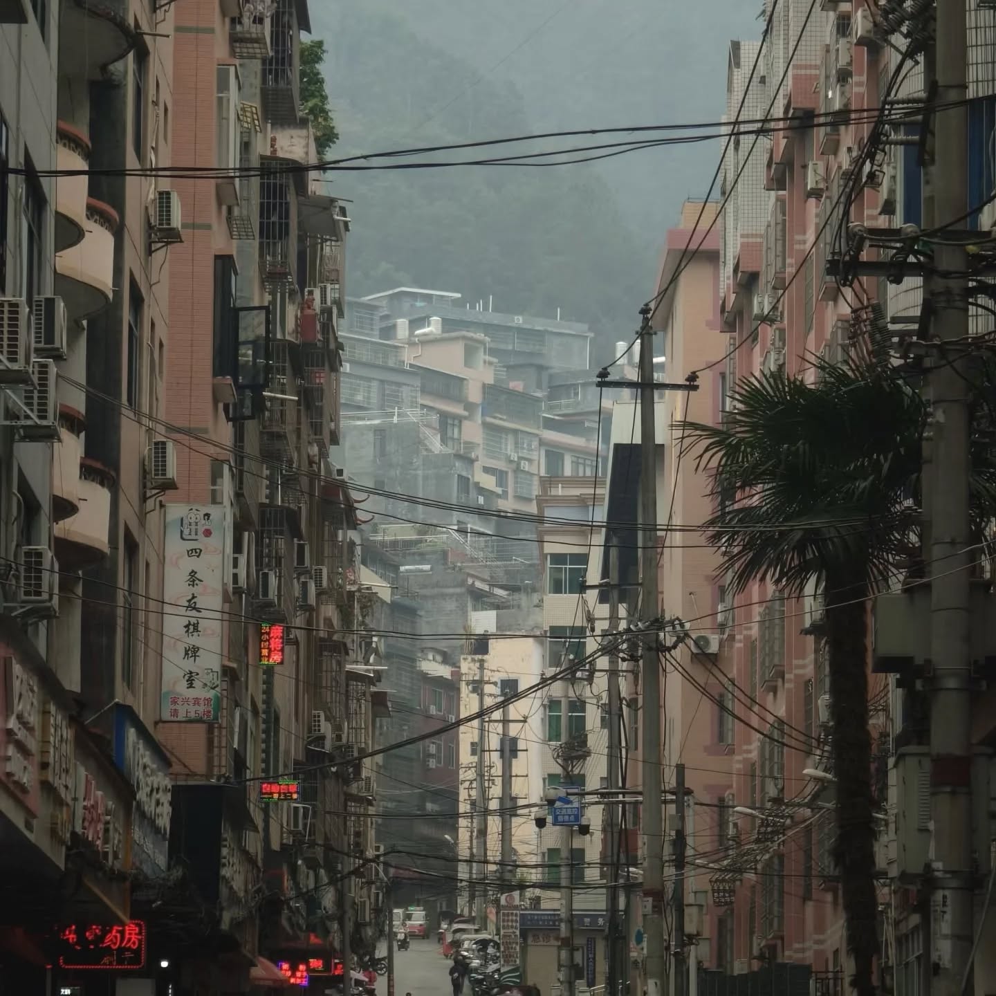 Een smalle straat tussen dicht op elkaar staande gebouwen in Nanning
